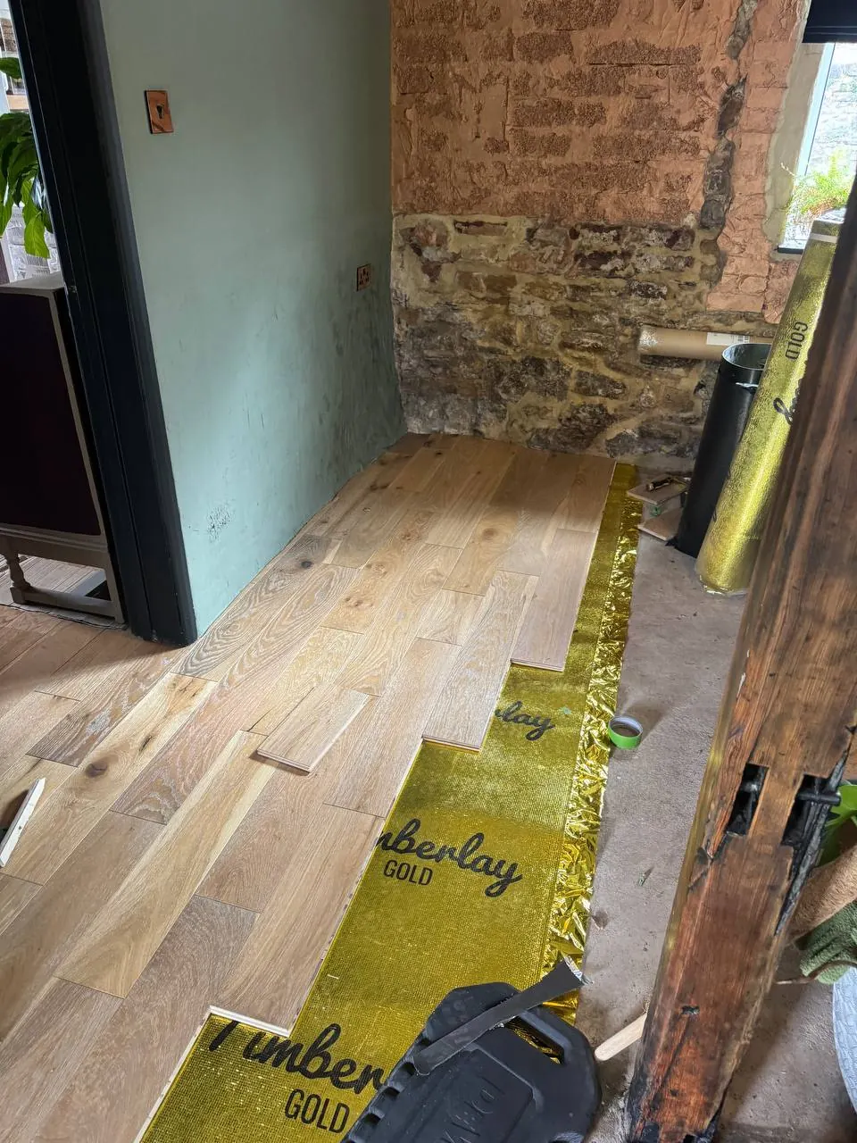 Engineered oak floor scribed to a stone wall, Cockermouth